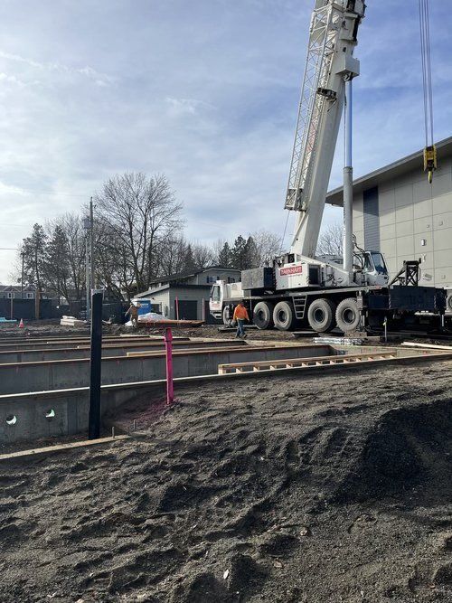 Crane lifting materials on an active construction site