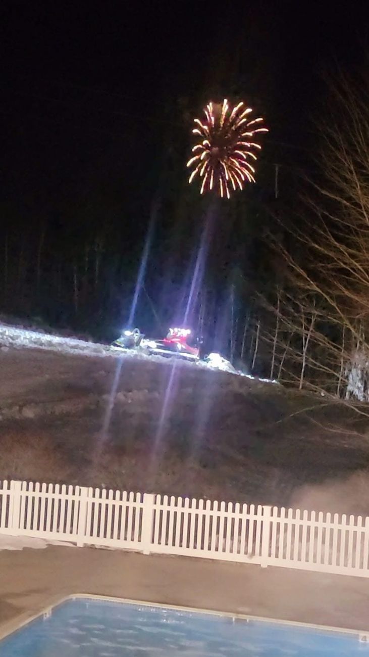 Fireworks over a ski slope at night