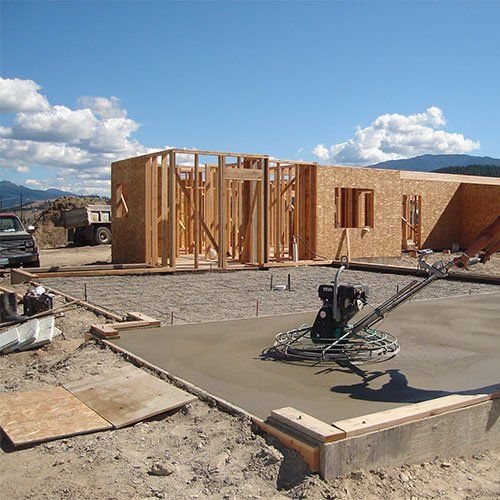 House framing with fresh concrete pour
